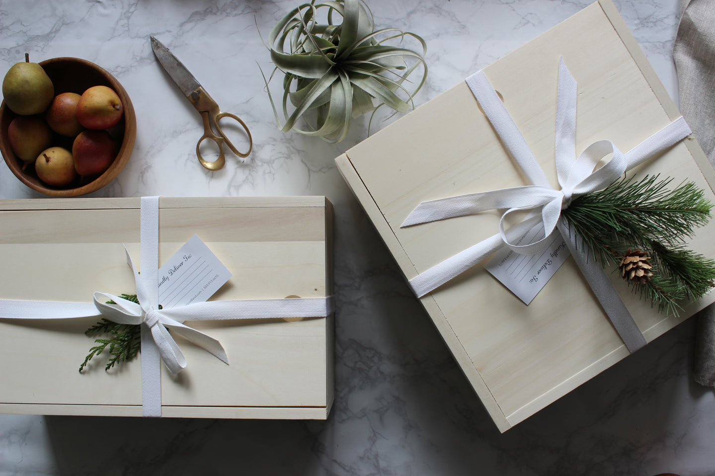 Iconic Parcel wood boxes on marble backdrop